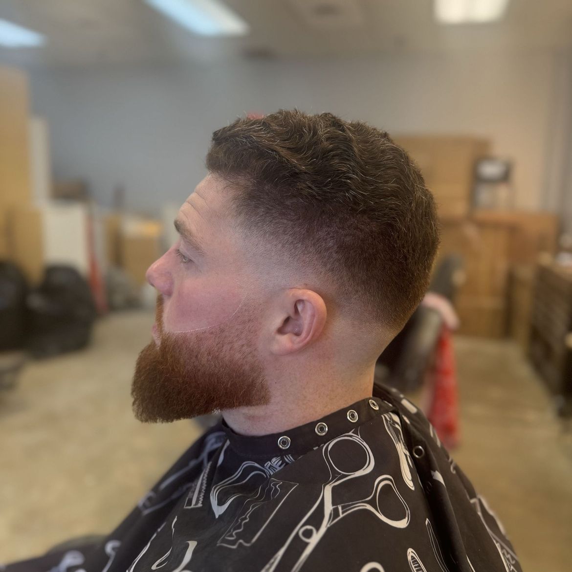 Professional men's fade haircut with beard styling